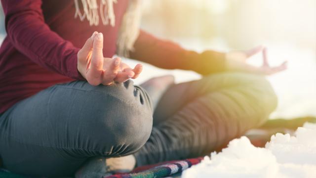 Serene lady relaxing and meditating doing yoga poses