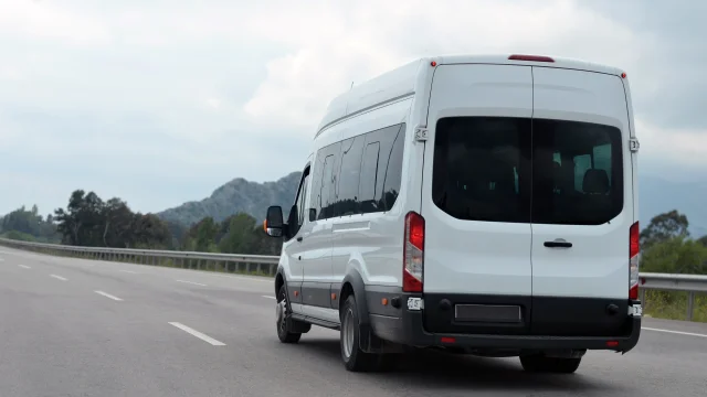 minibus in motion on a background of mountains