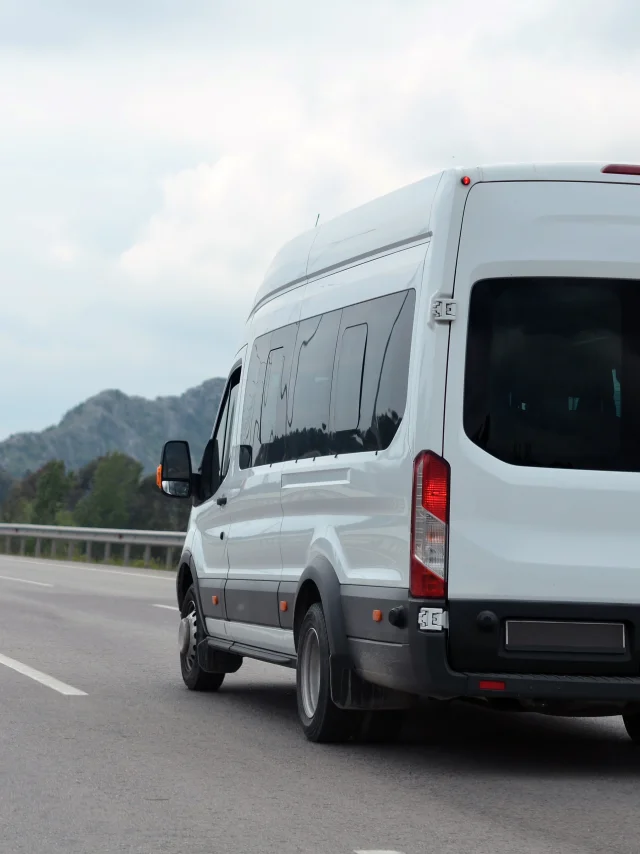 minibus in motion on a background of mountains